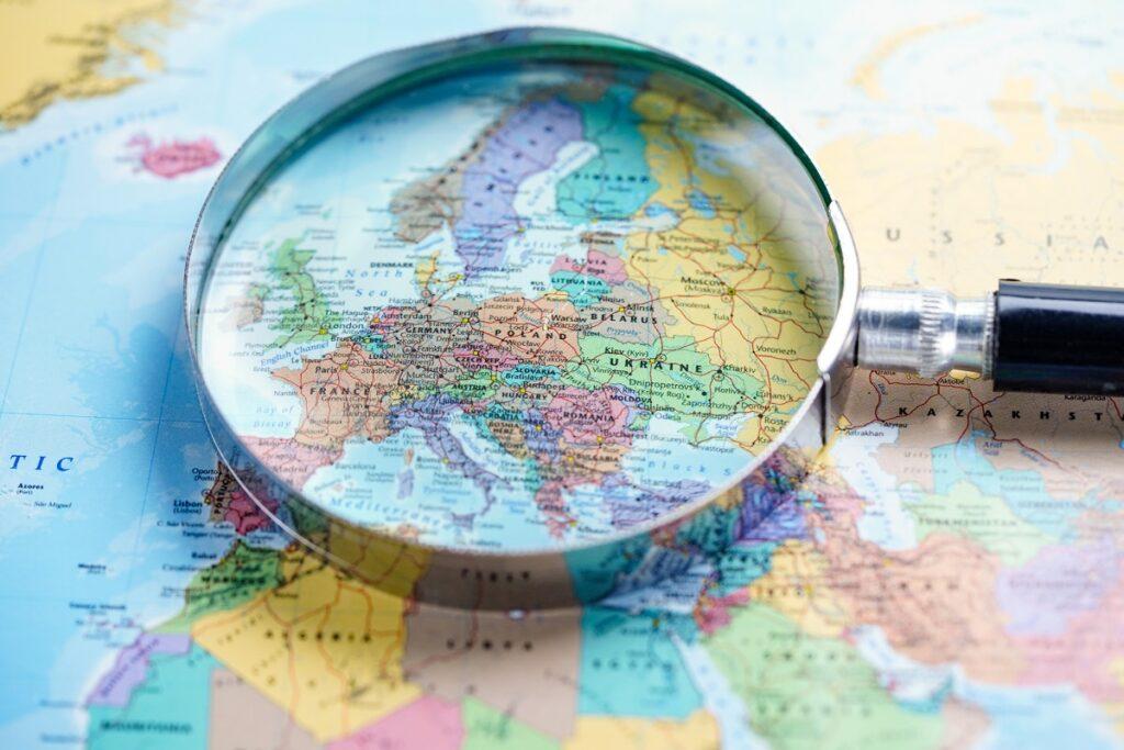 Finding the right independent baptist missionary for your church. Magnifying glass on map of world.